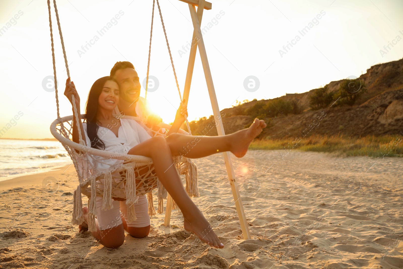 Photo of Happy young couple on beach at sunset