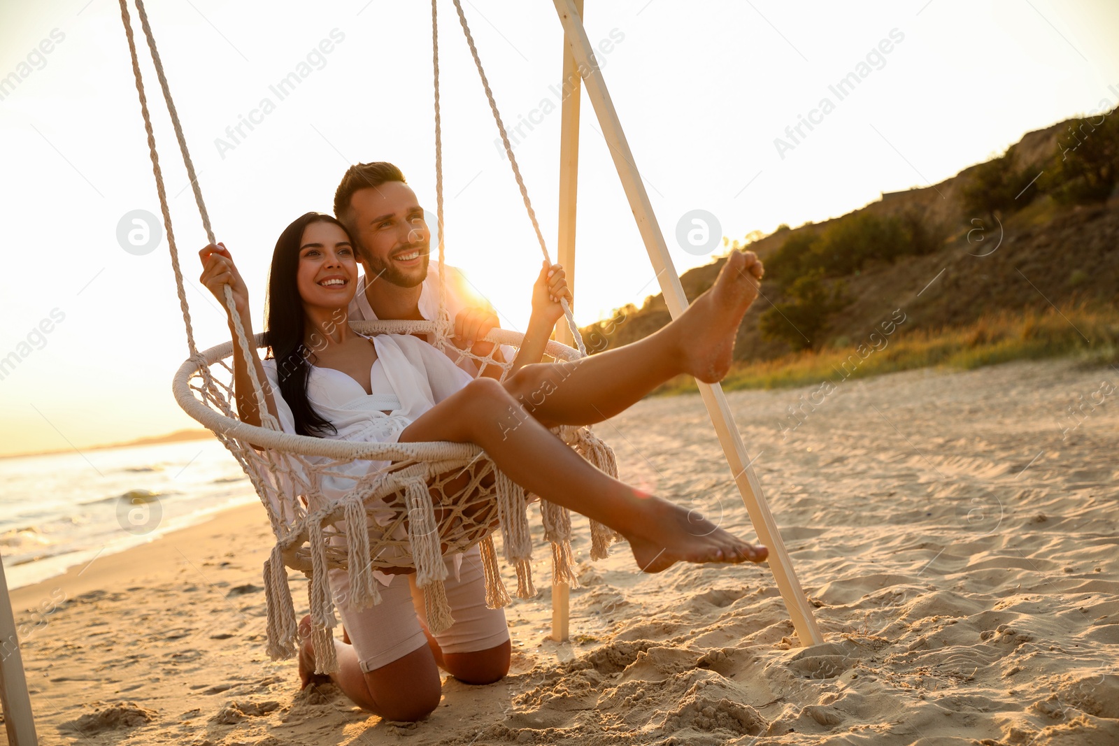 Photo of Happy young couple on beach at sunset