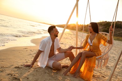 Photo of Happy young couple on beach at sunset