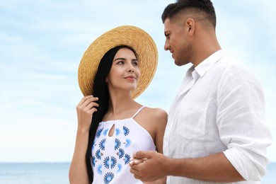 Photo of Lovely couple spending time together on beach