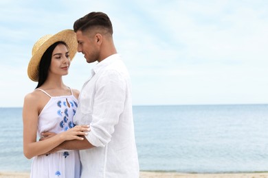 Photo of Lovely couple spending time together on beach. Space for text