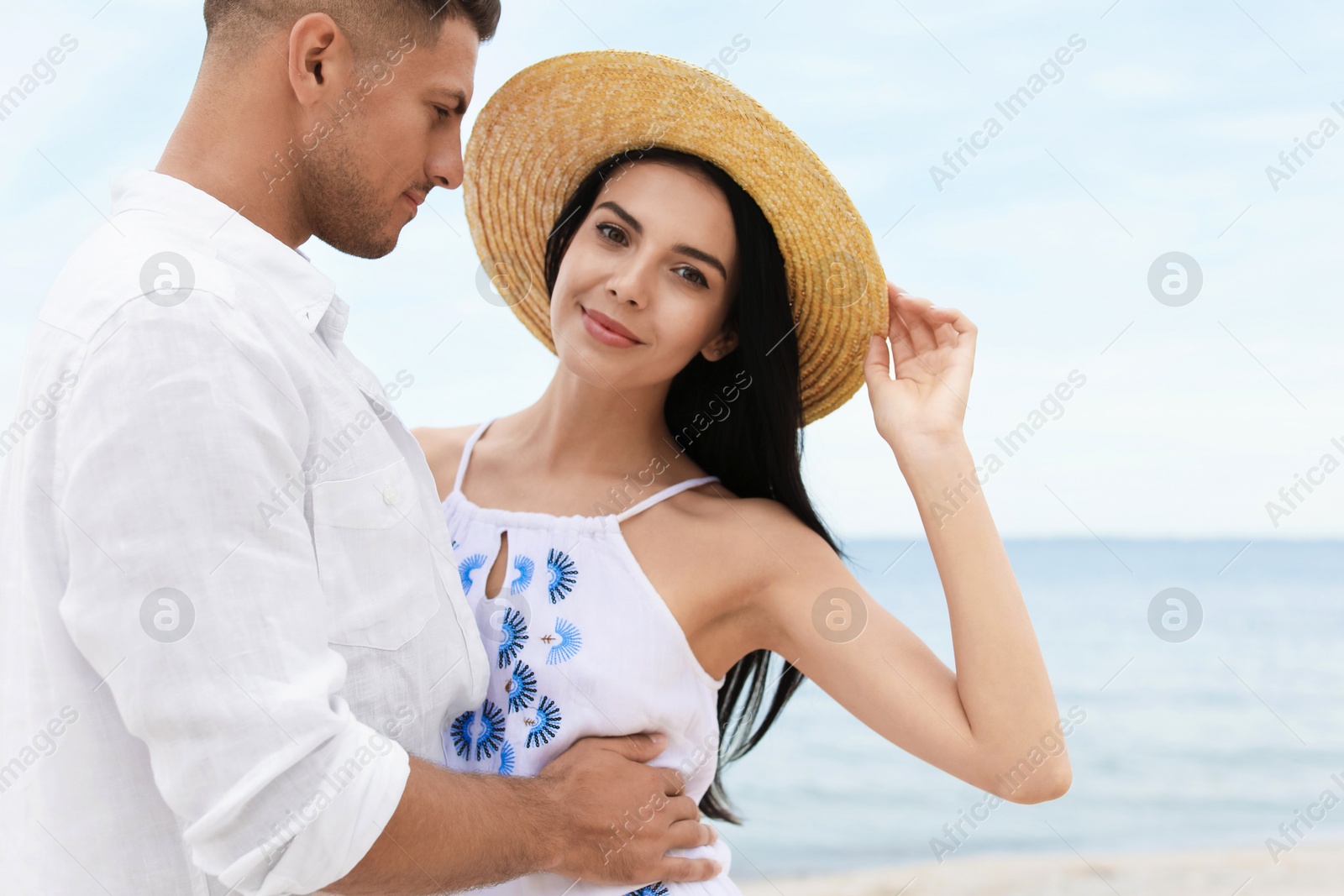 Photo of Lovely couple spending time together on beach