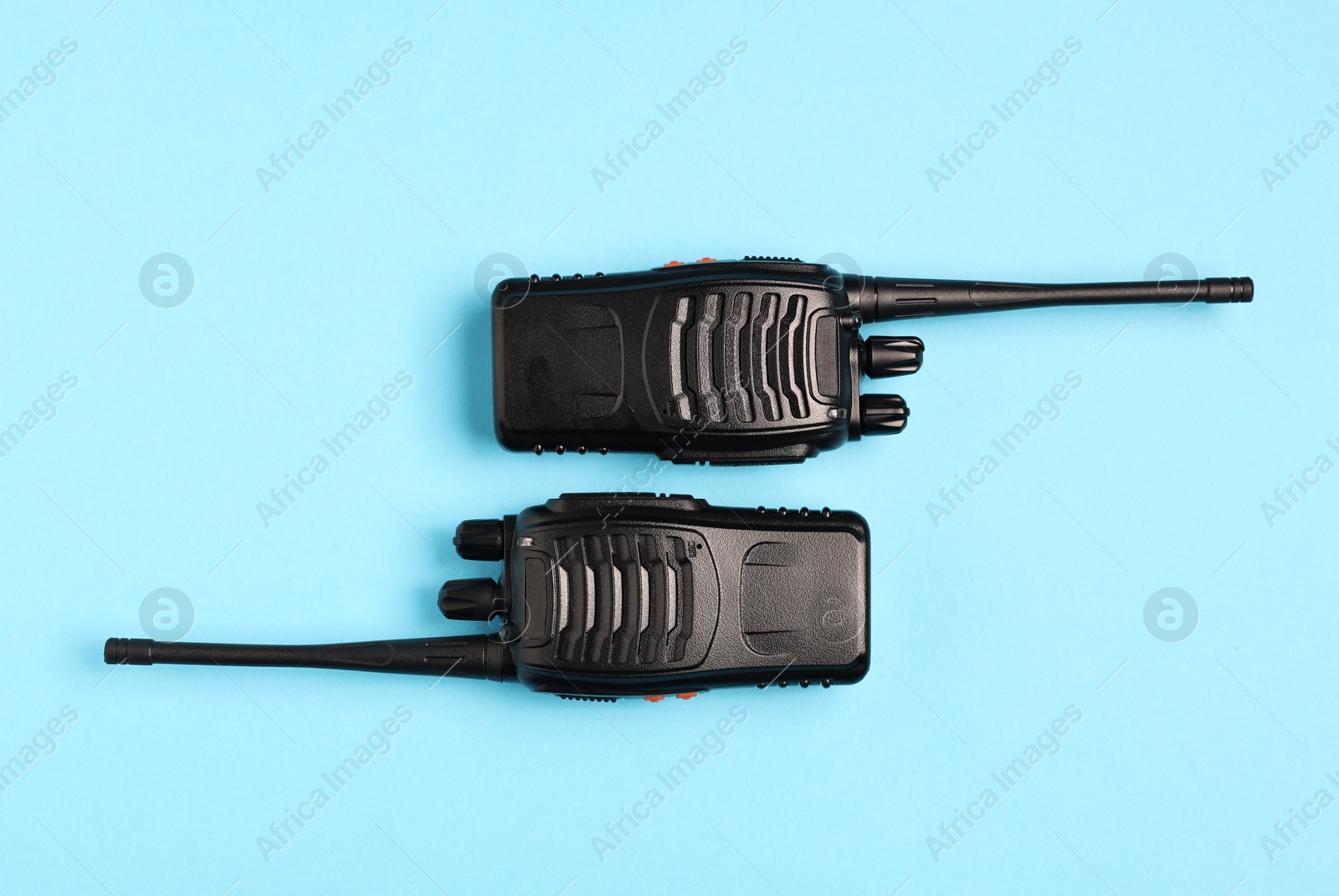 Photo of Walkie talkies on light blue background, top view