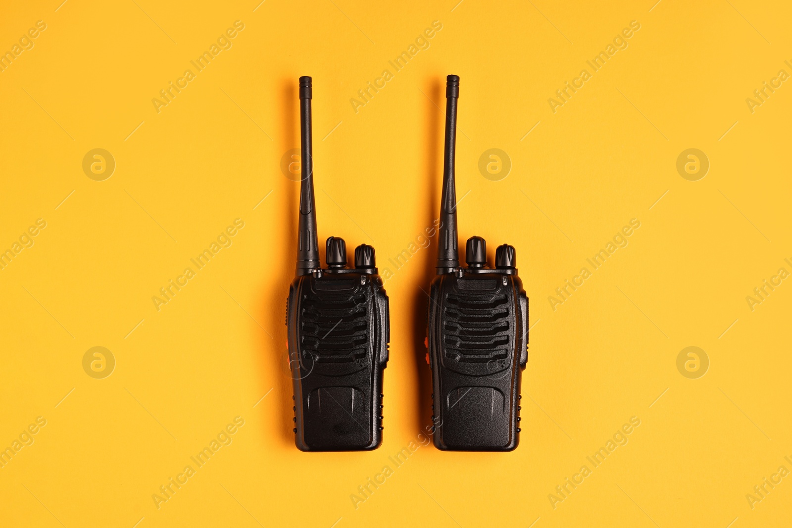 Photo of Walkie talkies on orange background, top view