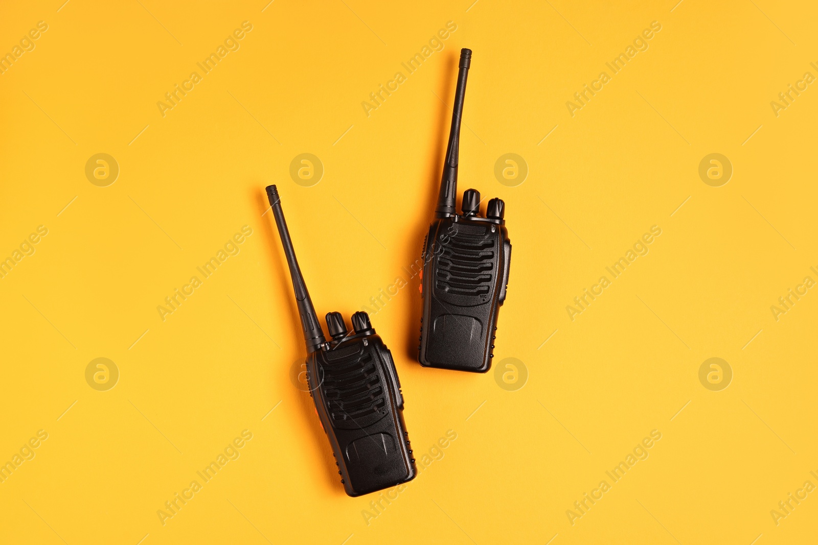 Photo of Walkie talkies on orange background, top view