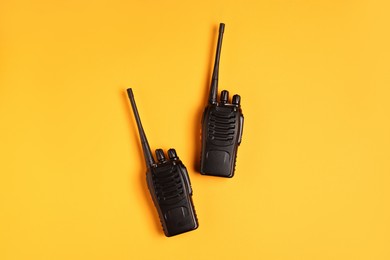 Photo of Walkie talkies on orange background, top view