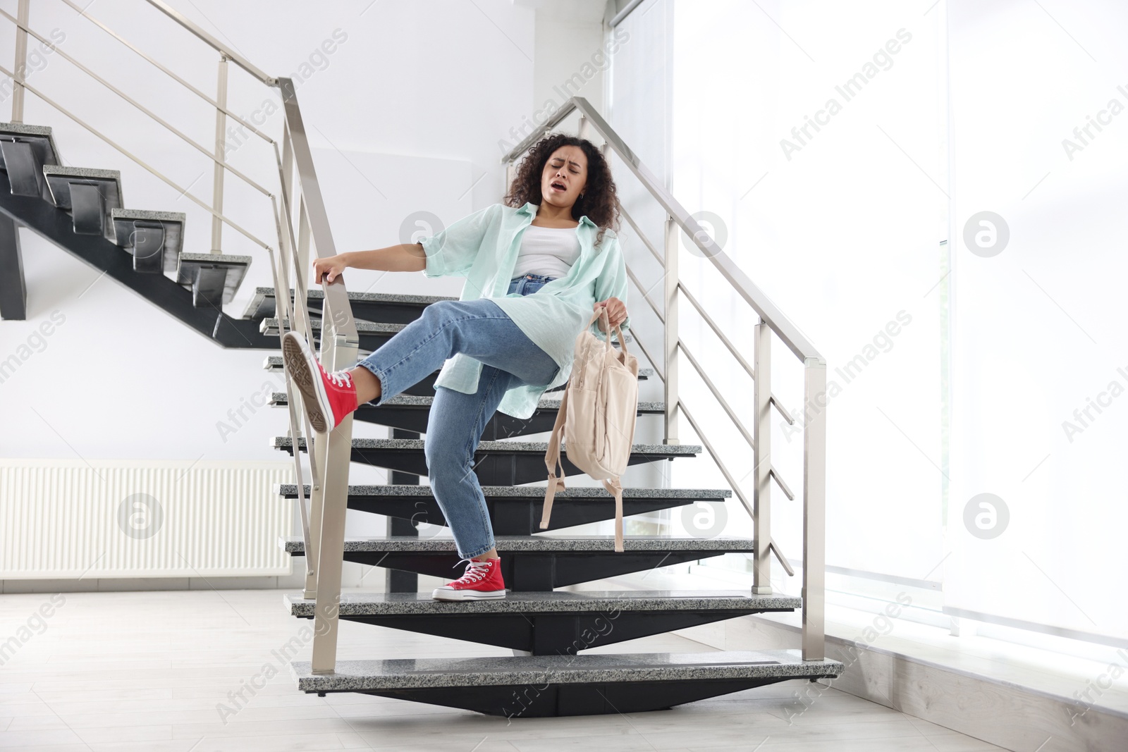 Photo of Woman falling on stairs in building. Dangerous accident