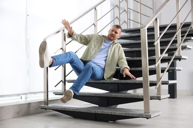 Photo of Man falling on stairs in building. Dangerous accident