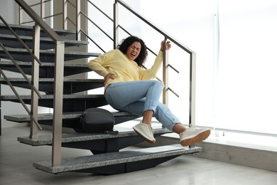 Photo of Injured woman on stairs in building after fall. Dangerous accident