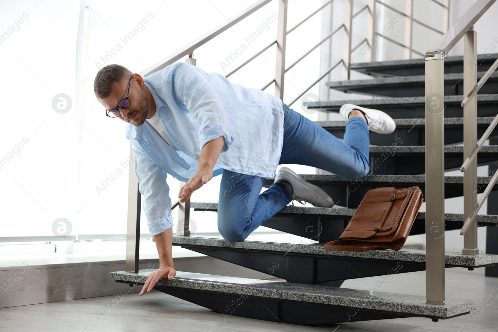 Photo of Man falling on stairs in building. Dangerous accident