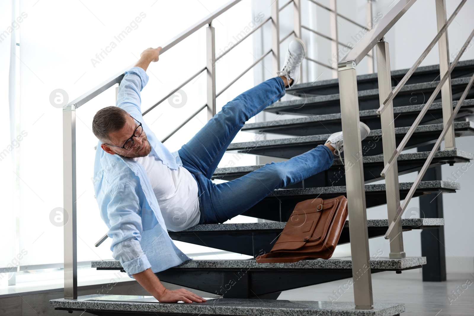 Photo of Man falling on stairs in building. Dangerous accident