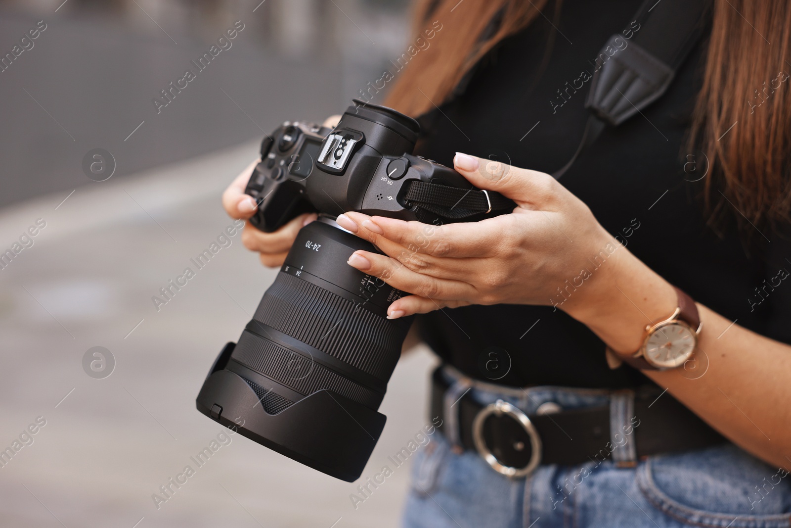 Photo of Professional photographer with digital camera outdoors, closeup