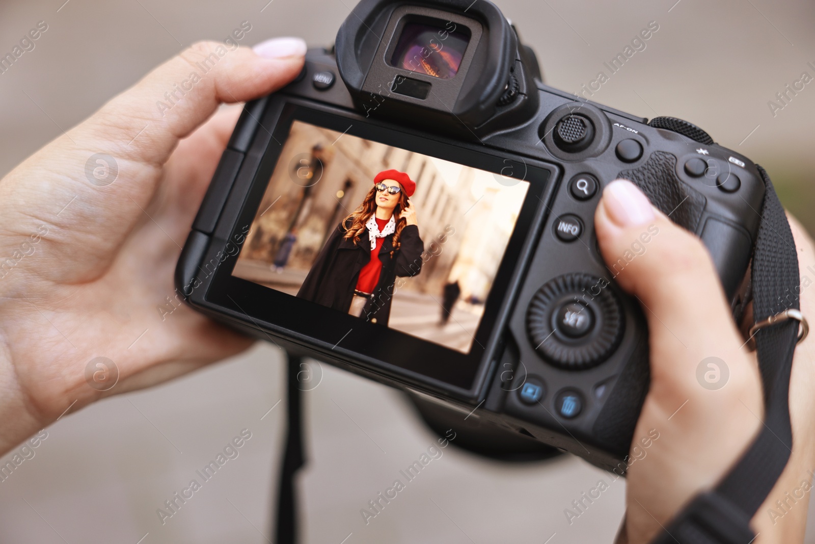 Photo of Professional photographer with digital camera outdoors, closeup