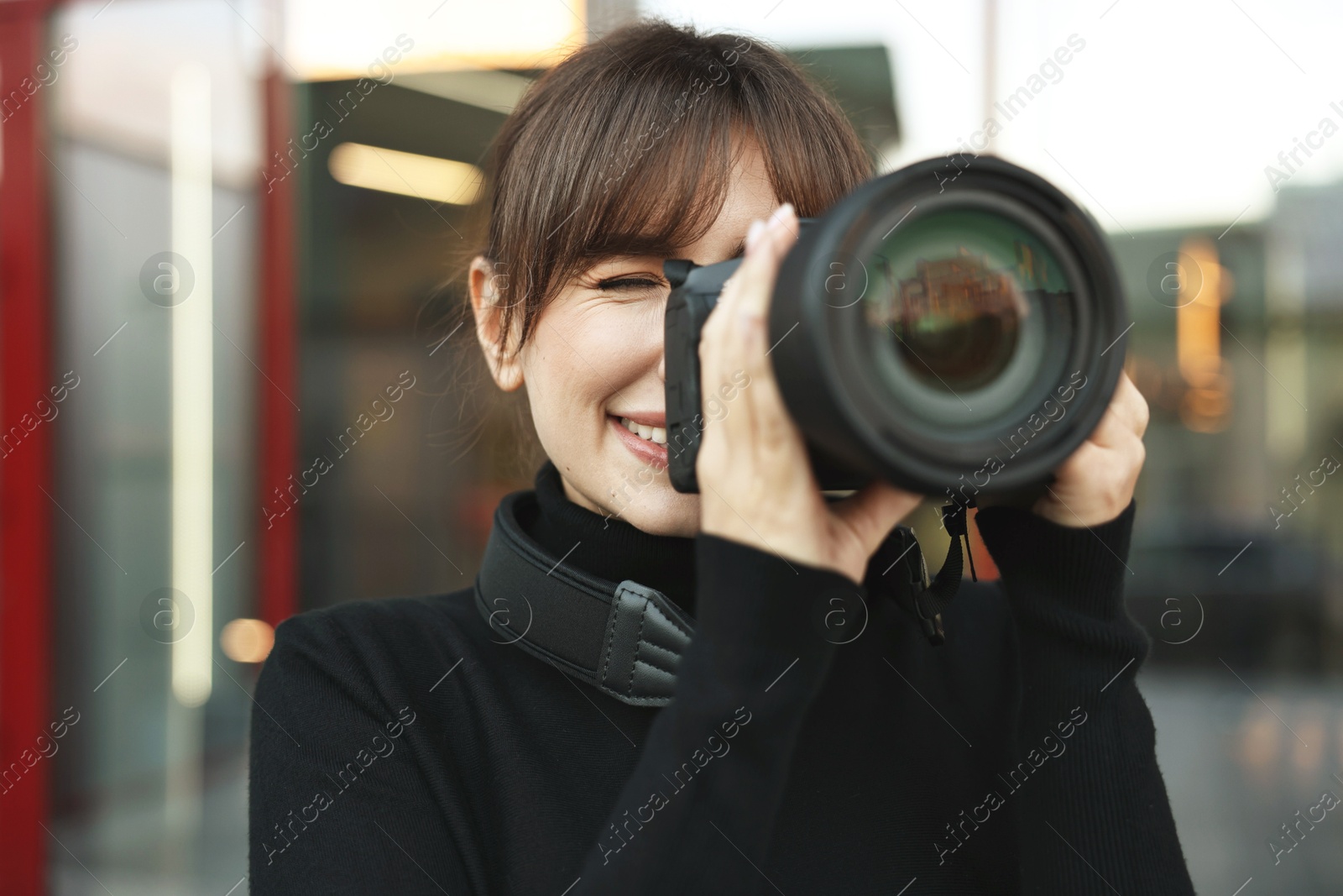 Photo of Professional photographer taking picture with camera outdoors, selective focus