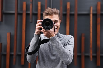 Photo of Professional photographer taking picture with camera outdoors