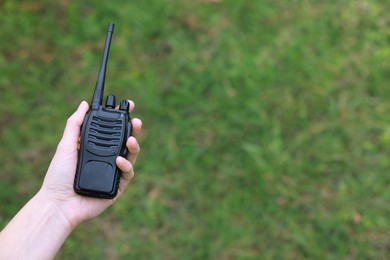 Photo of Woman with walkie talkie outdoors, closeup. Space for text