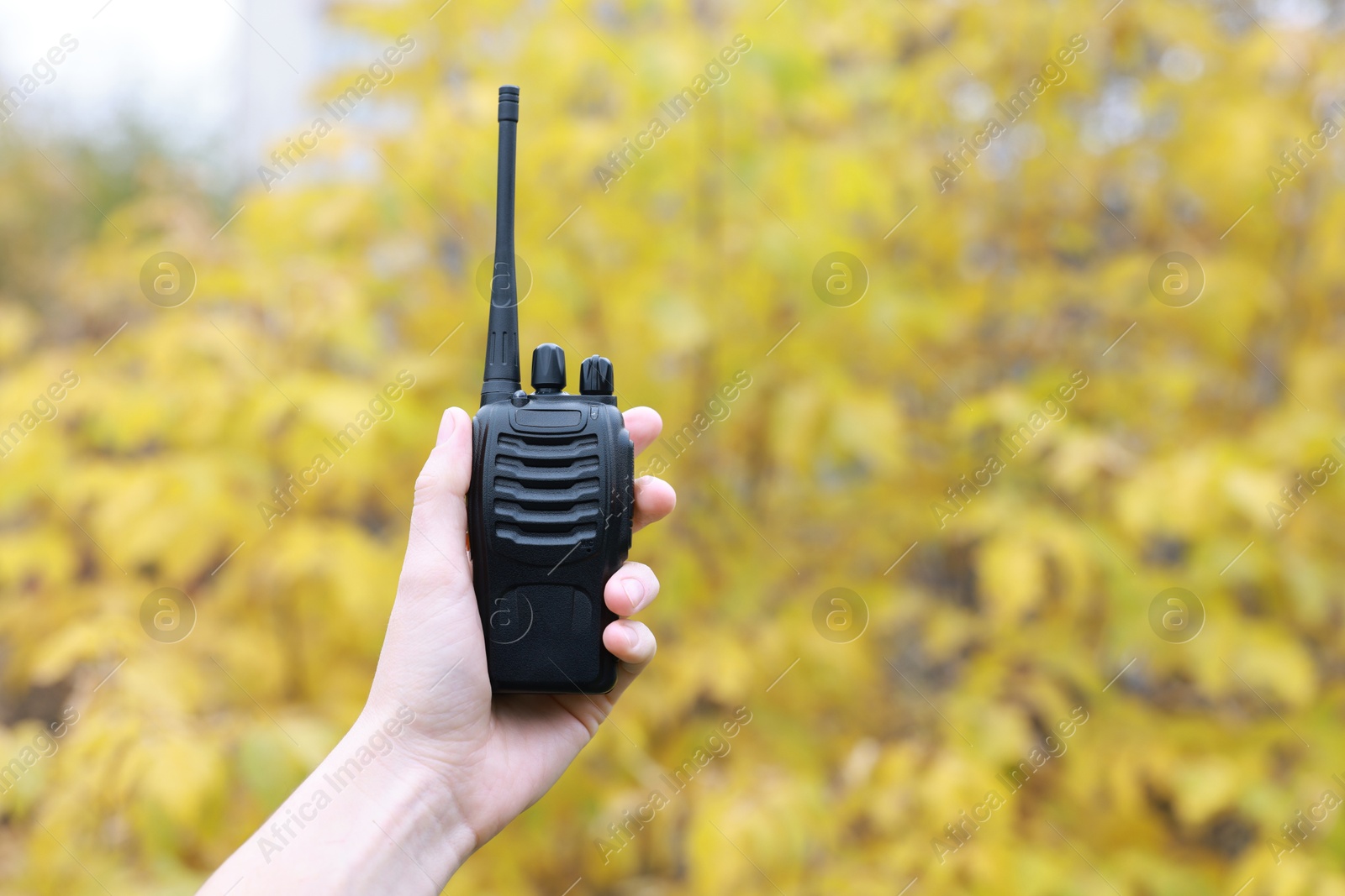 Photo of Woman with walkie talkie outdoors, closeup. Space for text