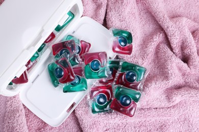 Photo of Laundry detergent capsules on terry towel, top view