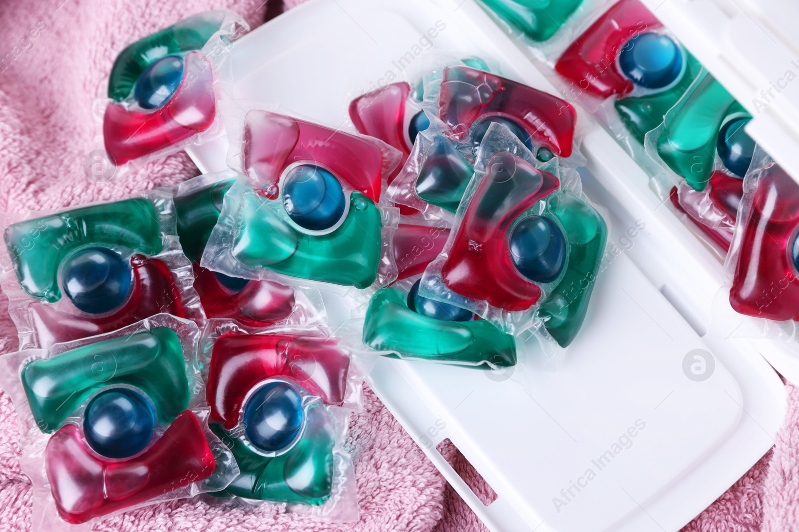 Photo of Laundry detergent capsules on terry towel, closeup