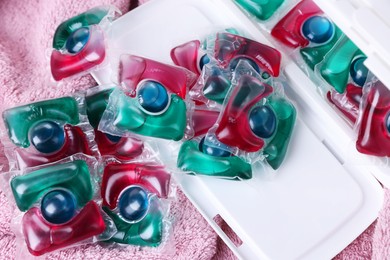 Photo of Laundry detergent capsules on terry towel, closeup