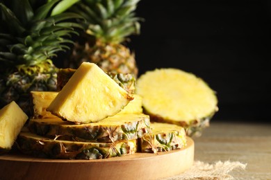 Photo of Slices of ripe pineapple on table, closeup