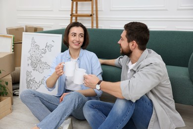 Photo of Moving day. Happy couple with coffee in their new home