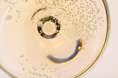 Photo of Champagne in glass as background, top view