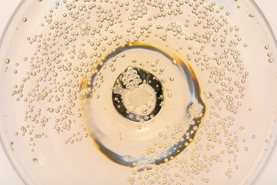 Photo of Champagne in glass as background, top view