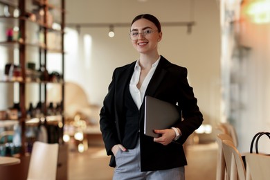 Photo of Woman in stylish formal suit with laptop indoors