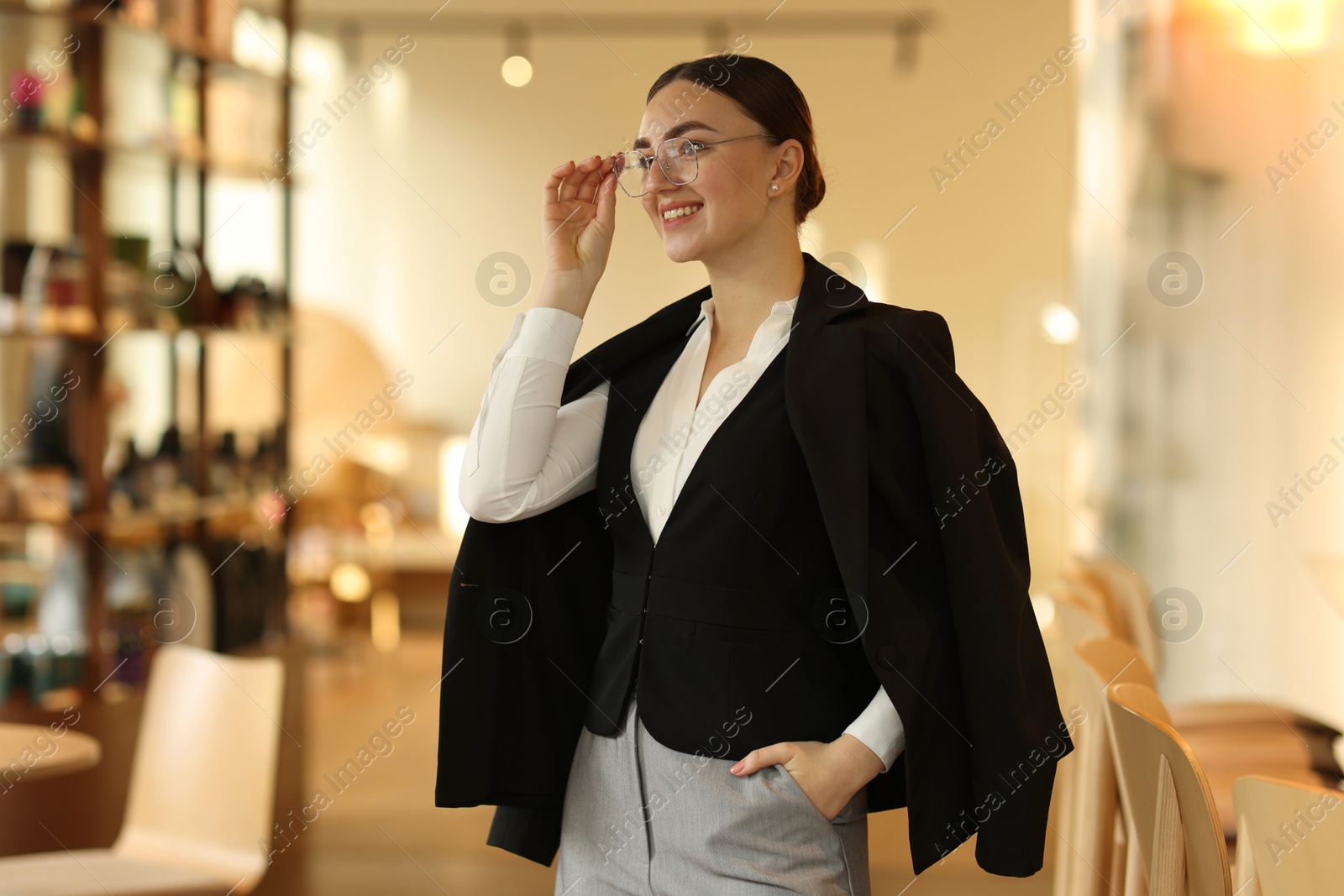 Photo of Beautiful woman in stylish formal suit indoors