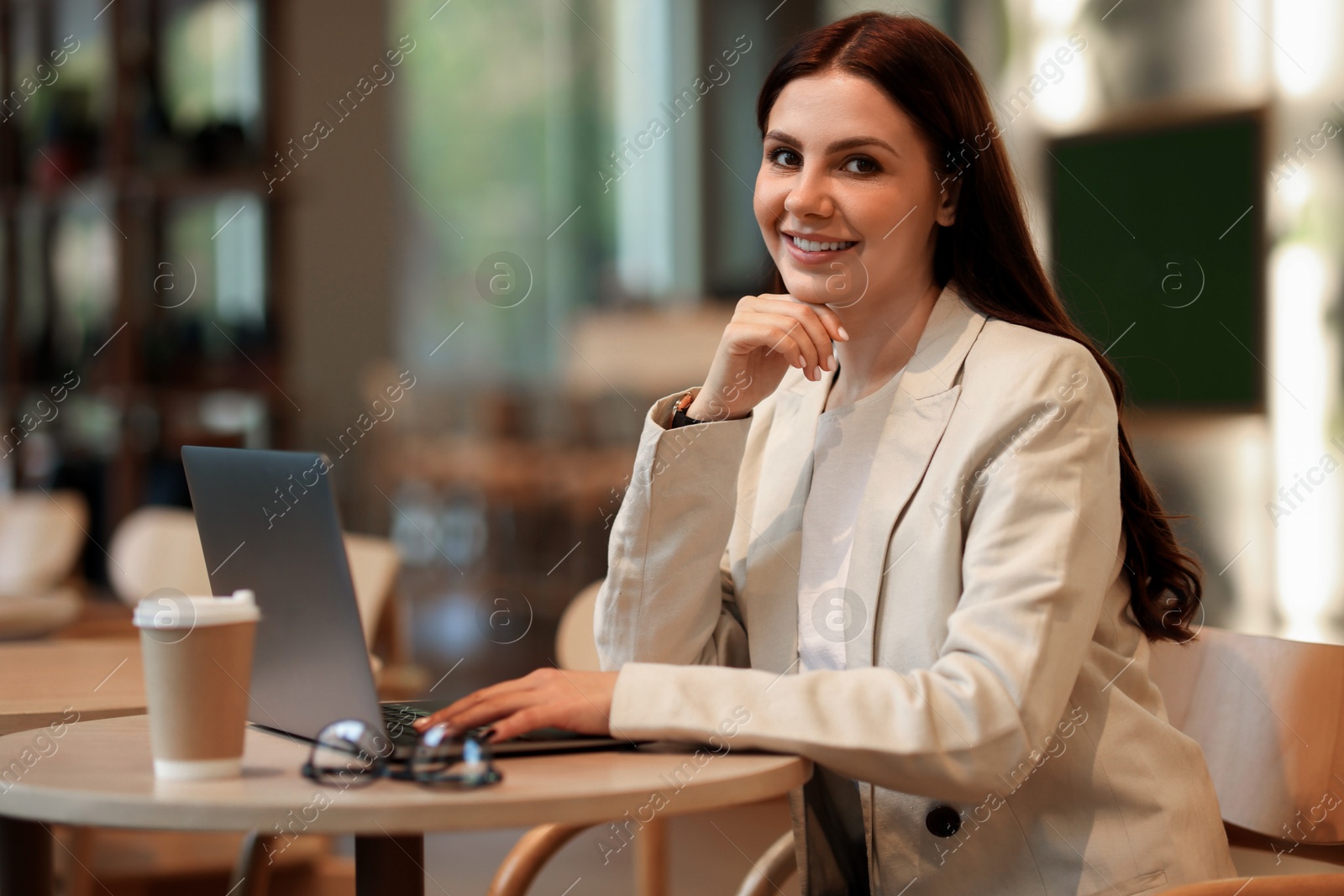 Photo of Woman in stylish formal suit working at table indoors