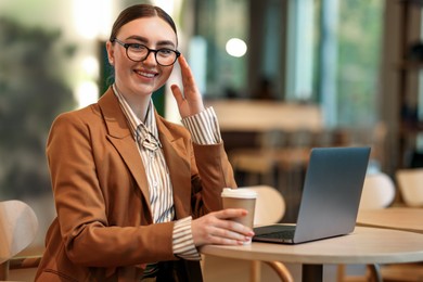 Photo of Woman in stylish formal suit working at table indoors