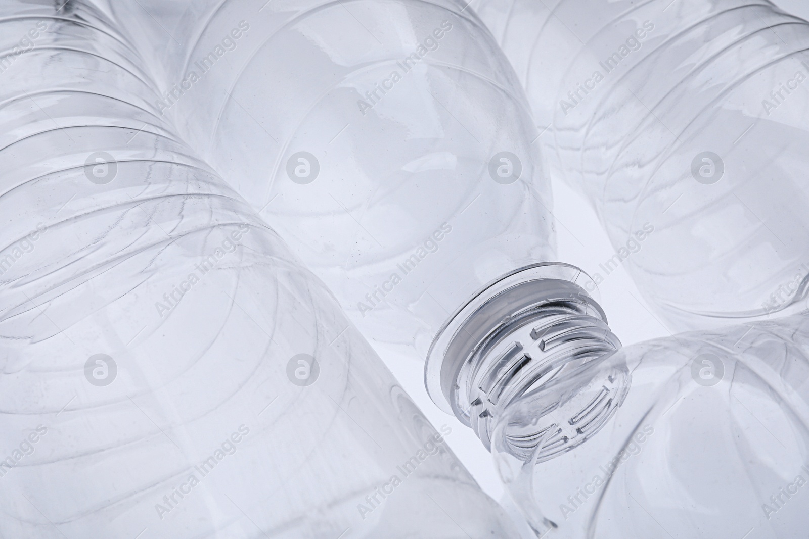 Photo of Empty plastic bottles on white background, closeup