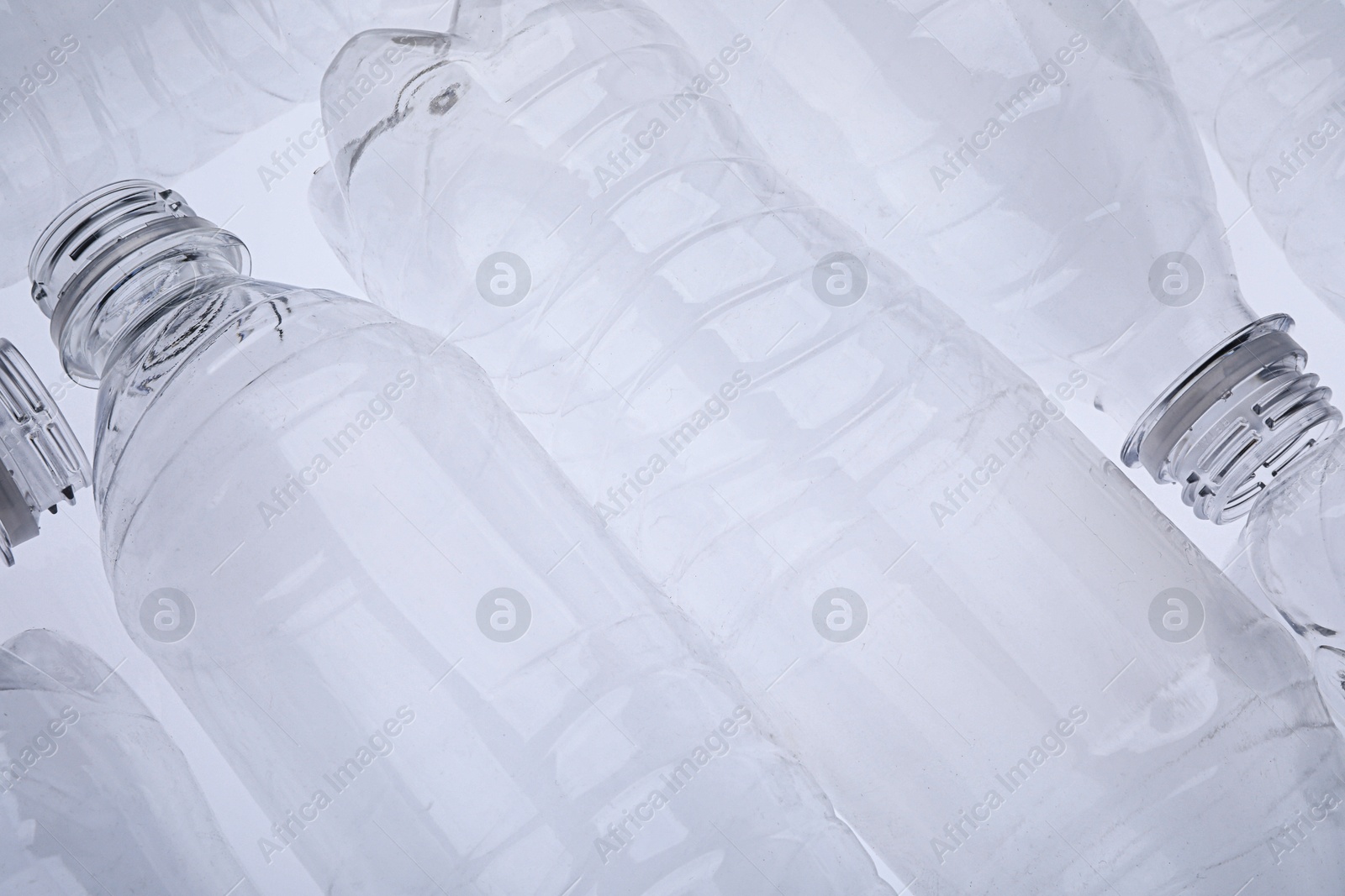 Photo of Empty plastic bottles on white background, closeup