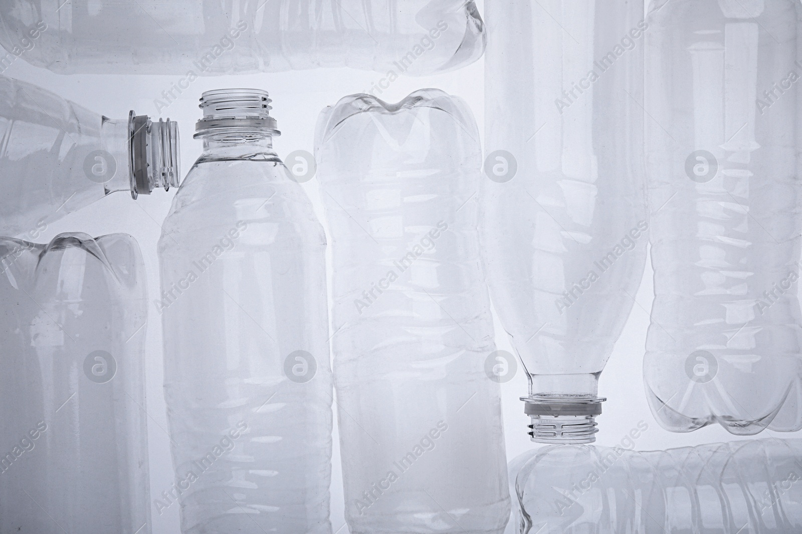 Photo of Empty plastic bottles on white background, top view