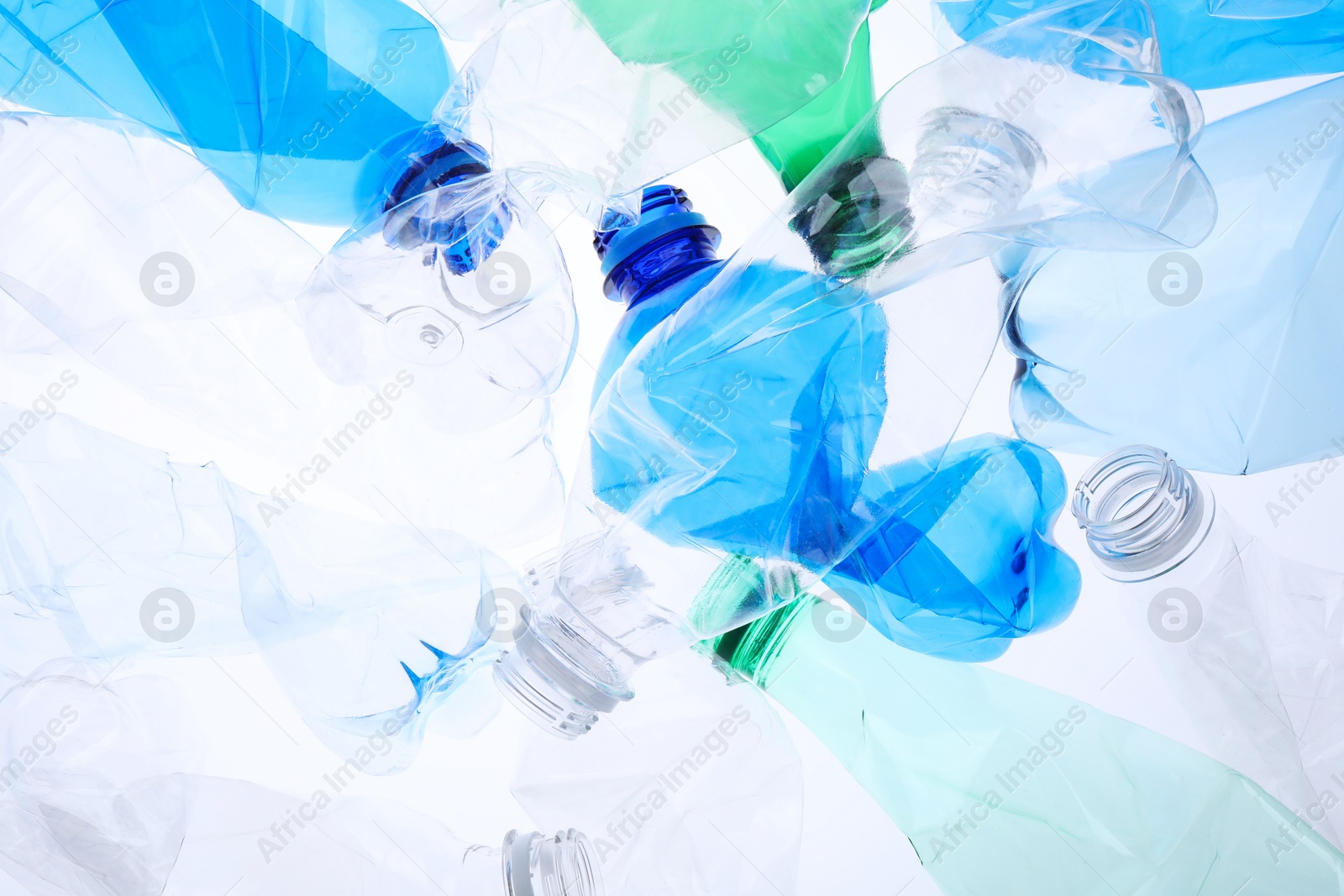 Photo of Crumpled plastic bottles on white background, closeup