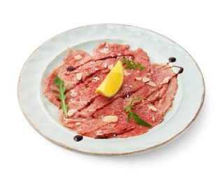 Delicious beef carpaccio with arugula, cheese, balsamic vinegar and lemon isolated on white