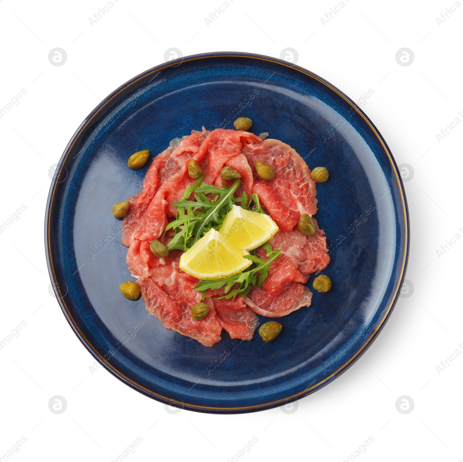 Photo of Fresh beef carpaccio with arugula, lemon and capers isolated on white, top view