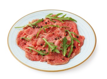 Photo of Fresh beef carpaccio with arugula and peppercorns isolated on white