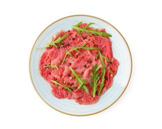 Photo of Fresh beef carpaccio with arugula and peppercorns isolated on white, top view