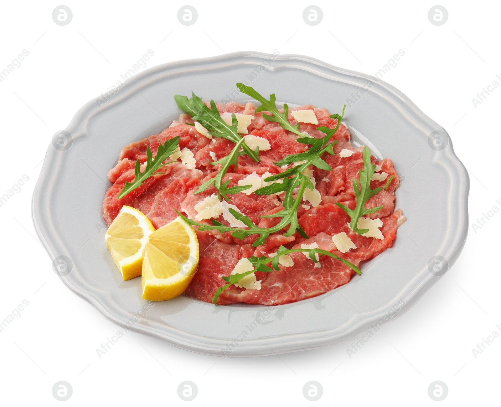 Photo of Fresh beef carpaccio with arugula, cheese and lemon isolated on white