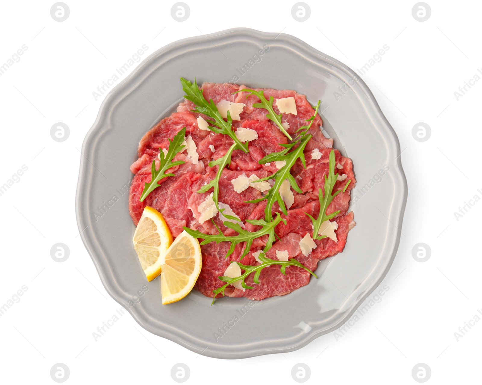 Photo of Fresh beef carpaccio with arugula, cheese and lemon isolated on white, top view