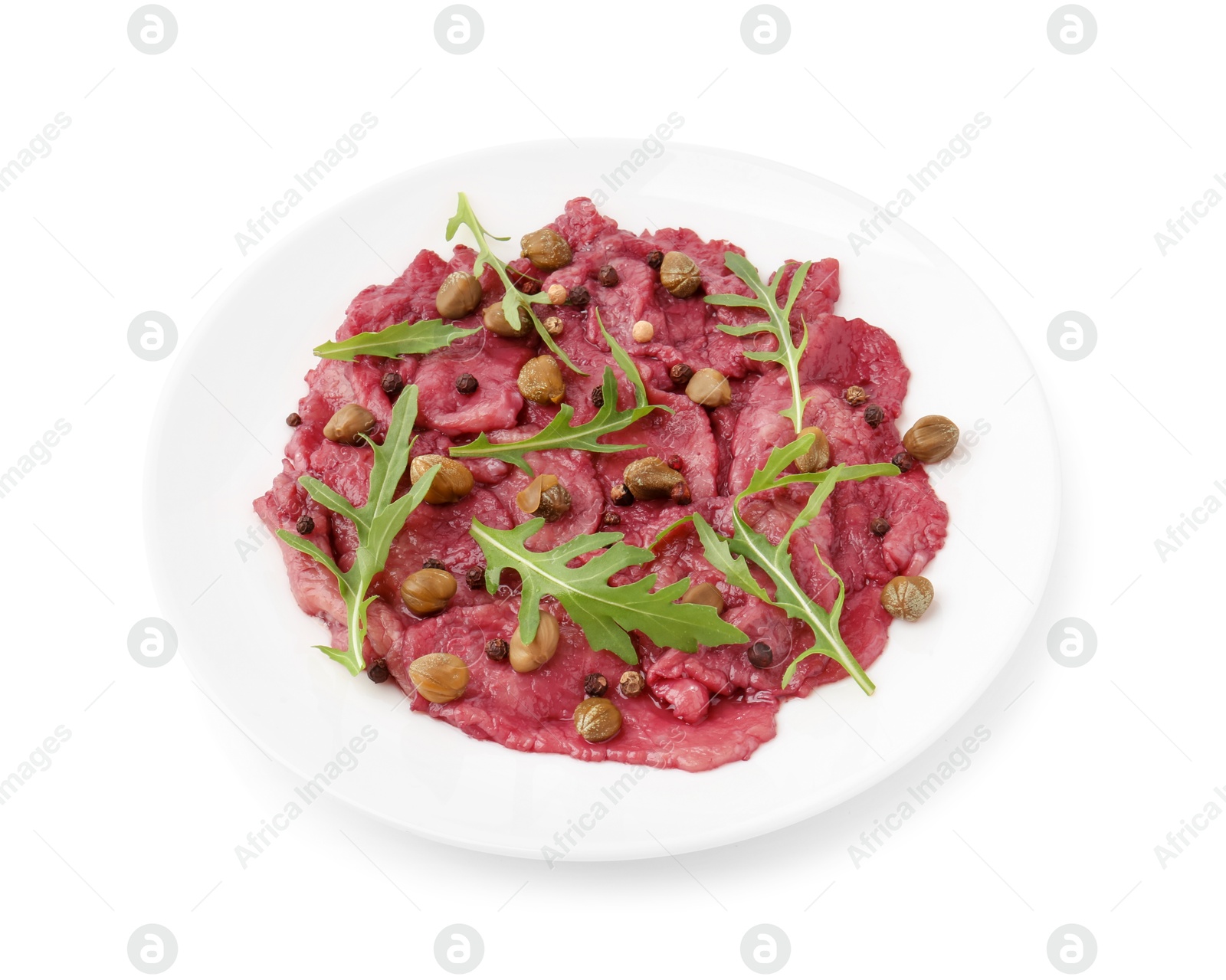 Photo of Fresh beef carpaccio with arugula and capers isolated on white