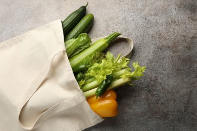 Photo of Shopper bag with products on grey background, top view and space for text. Eco friendly lifestyle