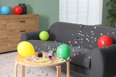 Photo of Shiny confetti, balloons and other party decor indoors