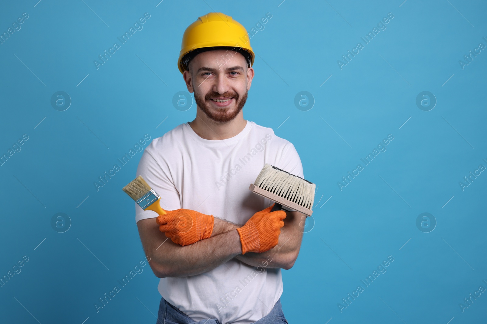 Photo of Man wearing hardhat with tools on blue background