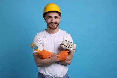 Photo of Man wearing hardhat with tools on blue background