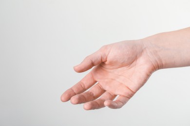 Photo of Woman with visible hand veins on white background, closeup. Space for text