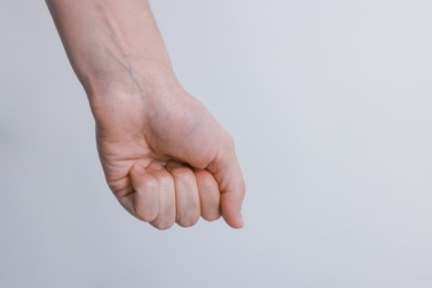 Photo of Woman with visible hand veins on white background, closeup