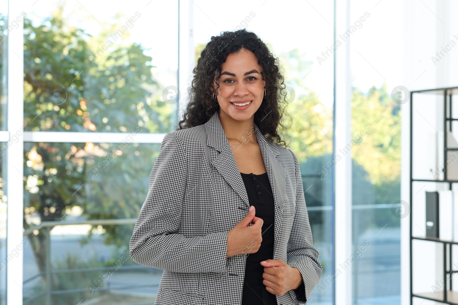 Photo of Portrait of young woman wearing stylish suit indoors